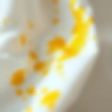 Understanding the Impact of Yellow Stains on White Clothing Close-up of yellow stains on white fabric