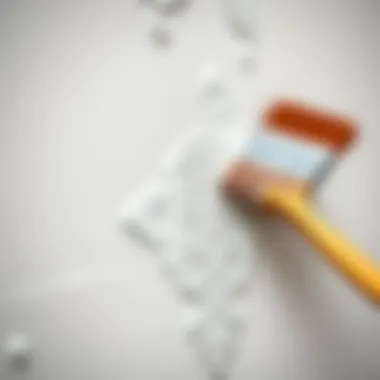 Close-up of a brush applying a unique design on the wall